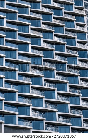 Close up building facade with repetitive pattern. Abstract architectural design with many windows for urban city development concept.