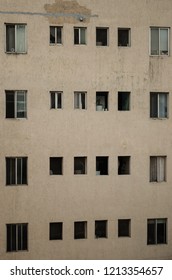close up to a building, pattern of windows of a gray building, close up to a large building,