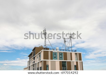 Close up building tower which has antenna on the rooftop