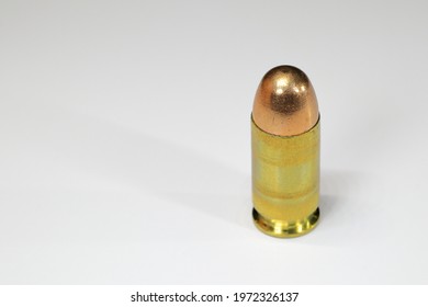 Close up of bullet 11 mm or .45 acp FMJ (Full Metal Jacket ) ready for use, isolate on white background reflection surface.