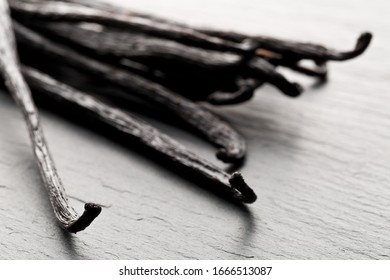 Close Up Of A Bundle Of Dried Bourbon Vanilla Beans Or Pods On Black Stone Board With Selective Focus