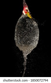 Close Up Of Burst Water Balloon On Black Background