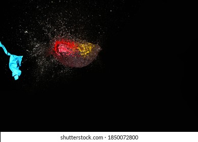 Close Up Of Burst Water Balloon On Black Background