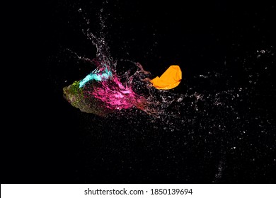 Close Up Of Burst Water Balloon On Black Background