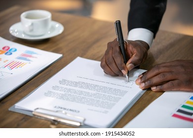 Close up business African American businessman signing contract or MOU making a deal, classic business contract or mutual agreement. - Shutterstock ID 1915434052