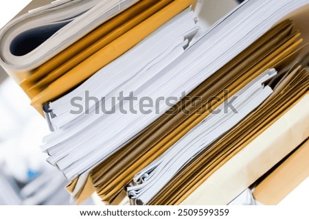 Close up of business documents stack on desk , report papers stackColorful business documents are placed in a filing cabinet in the office.