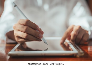 Close up of business hand signing contract on digital tablet, business person use electronic pen for sign agreement finance in office or workplace. communication technology. - Powered by Shutterstock