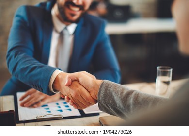 Close up of business handshake in the office. Selective focus on hands