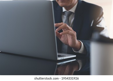 Close Up Of Business Man In Black Suit Making Facetime Video Conference Using Zoom Online Meeting App Via Laptop Computer At Office. Businessman Making Discussion On Teleconference Via Laptop