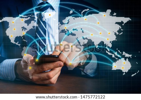 close up business man hand hold and pressing smartphone formal suit with double exposre of world logistic map import export ideas concept