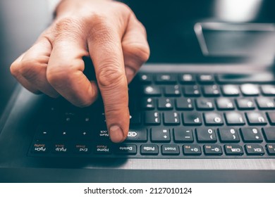Close up of business man hand working on laptop computer on wooden desk as concept  - Shutterstock ID 2127010124