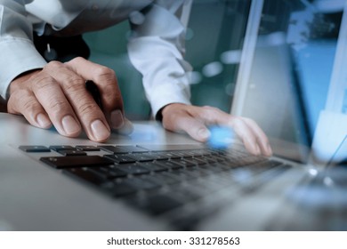 Close Up Of Business Man Hand Working On Blank Screen Laptop Computer On Wooden Desk As Concept