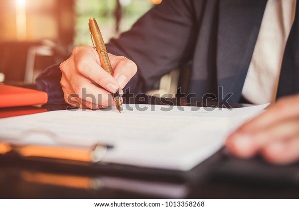 Close up business man reaching out sheet\
with contract agreement proposing to sign.Full and accurate\
details, individual who owns the business sign personally,director\
of the company,\
solicitor.\
