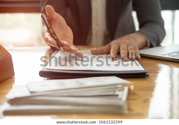 Close up business man reaching out sheet\
with contract agreement proposing to sign.Full and accurate\
details, individual who owns the business sign personally,director\
of the company,\
solicitor.\
