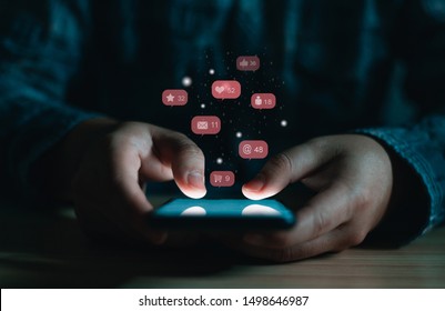 Close Up Of A Business Man Using Cell Phone Or  Smartphone With  Icons On Dark Room Background ,Businessman Using ,Social, Media, Marketing Concept / Blue Tone.