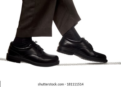 Close Up Of Business Man Walking A Tight Rope