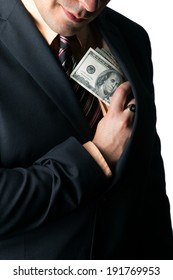 Close Up Of A Business Mans Hand Hiding Money In His Suit Jacket Pocket And A Smirk On His Face.