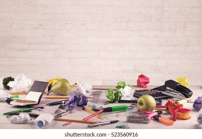 Close Up Of Business Office Desk With Pen Board Coffee In Front Of Empty White Brick Textured Wall Background.