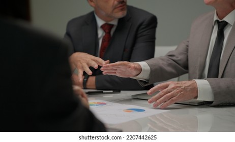 Close Up Of Business Officer Teamwork Brainstorming Talking, Finding Solution And Analyzing Project Using Paperwork To Explain Next Steps To Do Consulting Together In Meeting Room