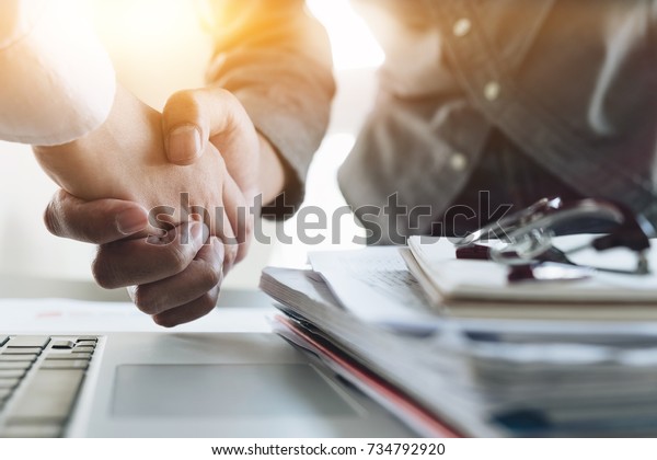 Close up of Business people shaking hands,\
finishing up meeting, business etiquette, congratulation, merger\
and acquisition concept