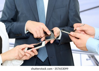 Close Up Of A Business People  Using Mobile Smart Phones