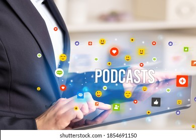 Close up of business person playing multimedia with social media icons and PODCASTS inscription
