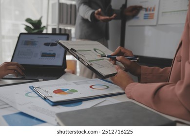 Close up of Business team analyzing income charts and graphs with modern laptop computer. Business analysis and strategy concept. - Powered by Shutterstock