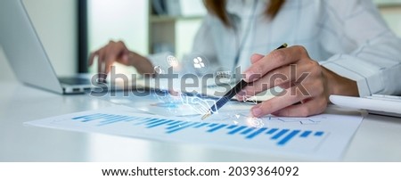 Close up of Business woman accountant or financial expert coins double exposure analyze business report graph finance chart corporate finance economy banking business stock market research concept.