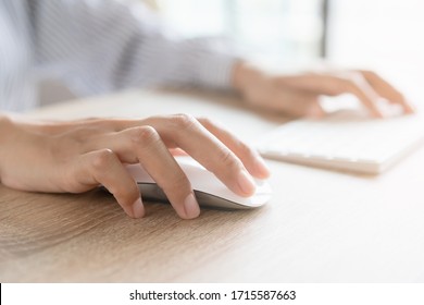 Close up of business woman hand typing on computer keyboard with the mouse while sitting working on the desk in the office or work from home