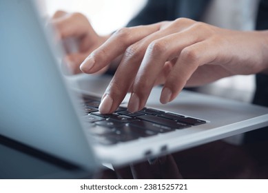 Close up of business woman hand typing on laptop computer keyboard with reflection on digital tablet on office table, online working, surfing the internet, distant job, remote work concept
