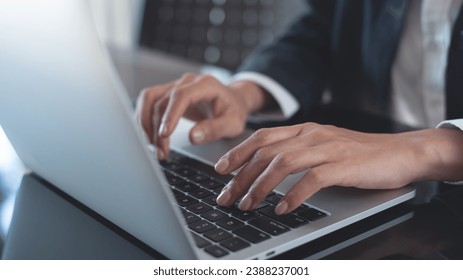 Close up of business woman hand typing on laptop computer keyboard with reflection on digital tablet on office table, online working, surfing the internet, distant job, remote work concept - Powered by Shutterstock