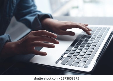 Close up of business woman hands typing on laptop computer and digital tablet, searching and surfing the internet on office desk, online working, telecommuting, freelancer at work concept - Powered by Shutterstock