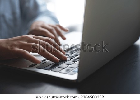 Close up of business woman hands typing on laptop computer, searching and surfing the internet on office desk, online working, telecommuting, freelancer at work concept