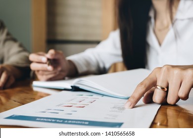 Close up of Business woman investment consultant analysis company annual financial report balance sheet statement working with documents graphs. Concept picture of economy, marketing