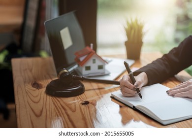 Close Up Business Woman And Lawyers Discussing Contract Papers With Brass Scale On Wooden Desk In Office. Law, Legal Services, Advice, Justice And Real Estate Concept.