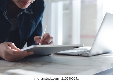 Close Up Of Business Woman Using Stylus Pen Signing E-document On Digital Tablet During Working On Laptop Computer At Modern Office, Business Technology, E-signing, Electronic Signature Concept