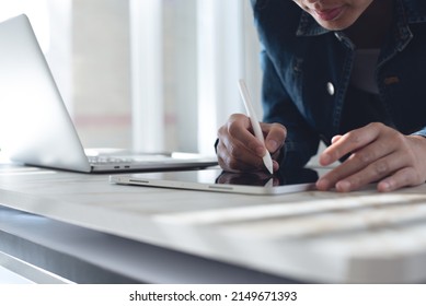 Close Up Of Business Woman Using Stylus Pen Signing E-document On Digital Tablet During Working On Laptop Computer At Modern Office, Business Technology, E-signing, Electronic Signature Concept