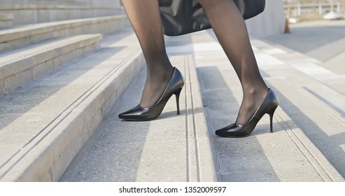 Close Up Of Business Woman Walking Up On Stairs In City Street With Laptop Bag