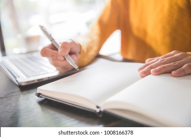close up of business woman's hands using laptop and writing in notepad. Working on project concept - Shutterstock ID 1008166378