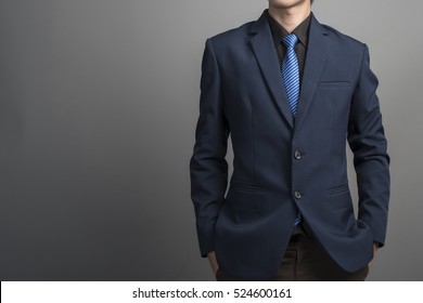 Close Up Of Businessman In Blue Suit Confident On Gray Background