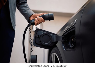 Close up of businessman charging his hybrid car.  - Powered by Shutterstock