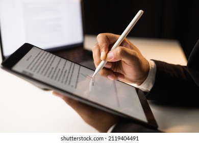Close up businessman hand electronic Signature on Tablet by Stylus. Write business agreement of contract. Man signing contract on tablet. Business and technology concept. - Shutterstock ID 2119404491