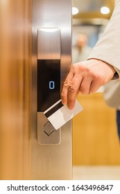 Close Up Of Businessman Hand Holding Key Card To Unlock Elevator Access, Corporate Building Security Concept.