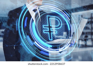 Close up of businessman hand holding laptop with creative glowing round ruble icon and map hologram on blurry office interior background. Finance, currency and global business technologies concept. 