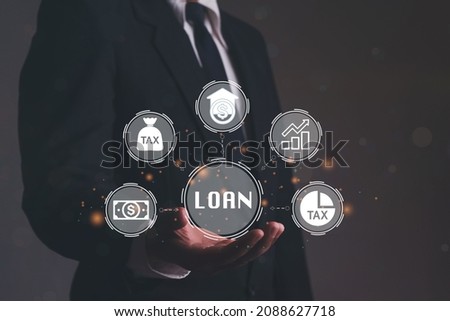 Close up of businessman hand holding LOAN icons over the Network connection. Non performing loans. Businessman pressing a Business Loan concept button.