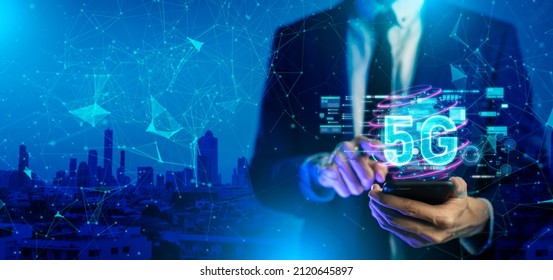 Close up of businessman hand holding a phone with a 5G hologram in coffee shop. 5G network wireless systems.The concept of 5G network, high-speed mobile Internet, new generation networks.