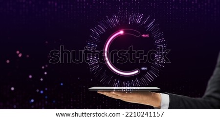 Close up of businessman hand holding tablet or smartphone with abstract glowing max and min scale hologram on dark background. Volume control and future concept