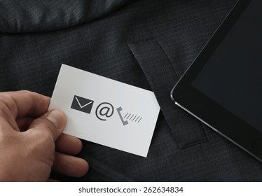 Close Up Of Businessman Hand Picking Business Card Icon Contact Us Concept From The Pocket Of Gray Suit Jacket Background