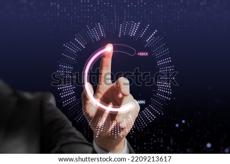 Close up of businessman hand pointing at abstract glowing max and min scale hologram on dark background. Volume control and future concept