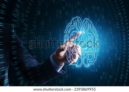 Close up of businessman hand pointing at glowing brain hologram with binary coding on blue background. Programming, machine learning and artificial intelligence concept
